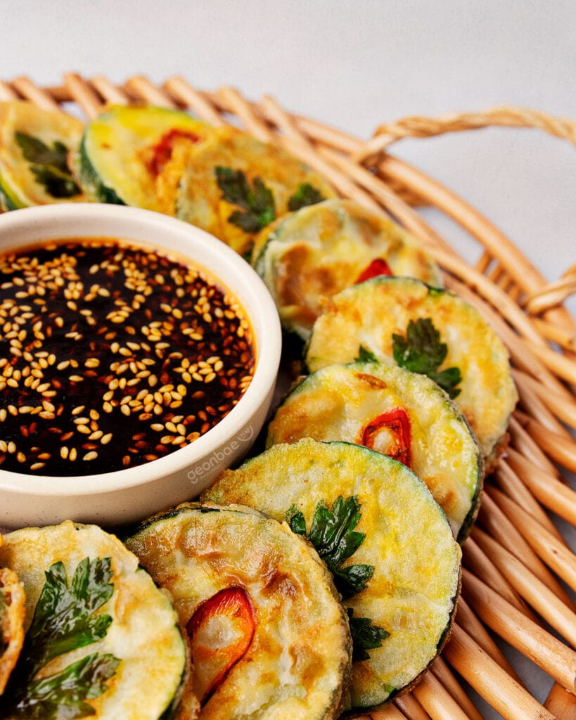 hobak jeon laid on rattan serving tray with dipping sauce