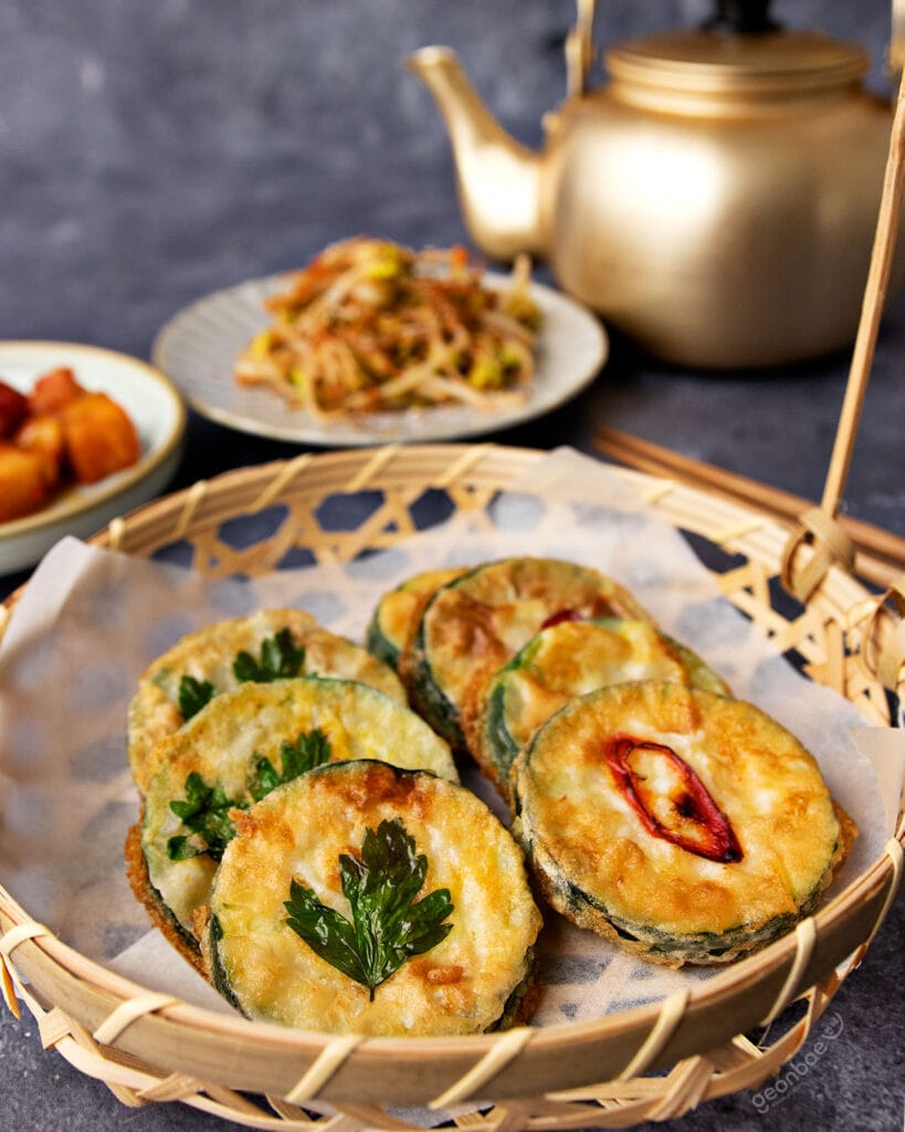 korean pan fried zucchini fritters served with banchan and makgeolli