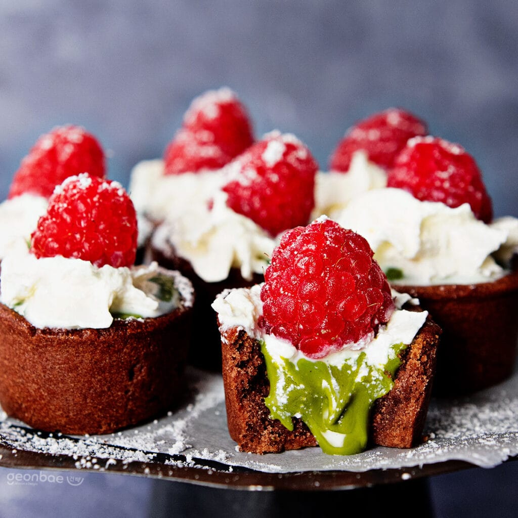 green tea chocolate tarts topped with raspberries and cream
